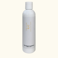 White bottle of 'The Glow Collection' Daily Repair Conditioner on a white background