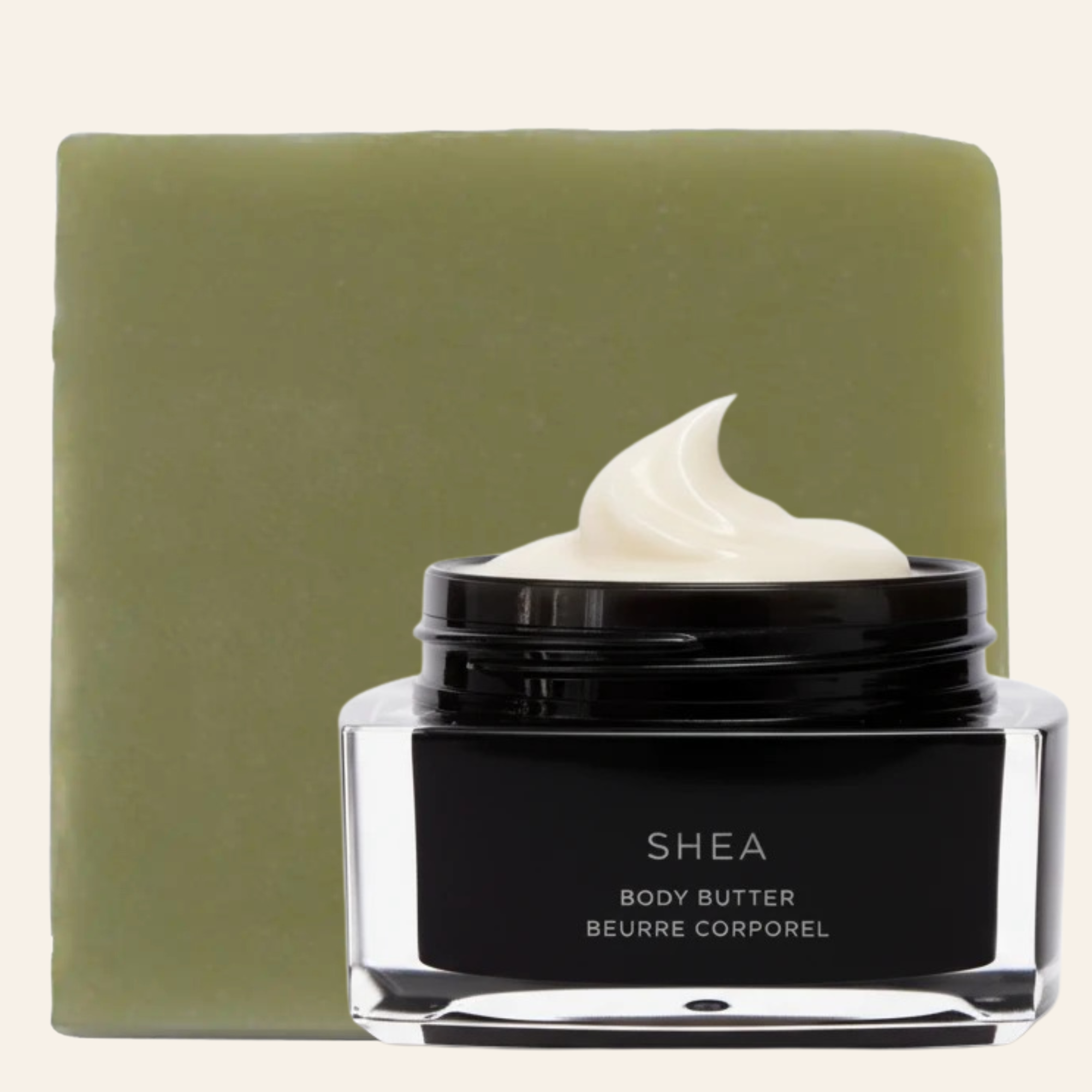 Jar of shea body butter with a green bar of soap in the background
