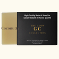 Coconutty soap bar next to its packaging with 'The Glow GC Collection' branding.