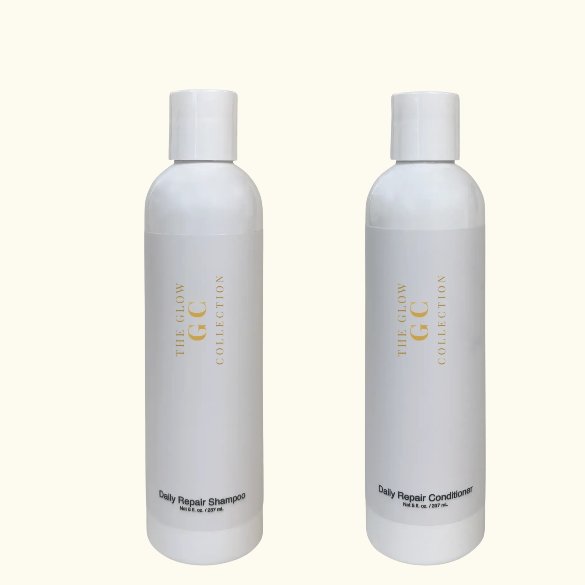 Two bottles of 'The Glow GC Collection' Daily Repair Shampoo and Conditioner on a white background